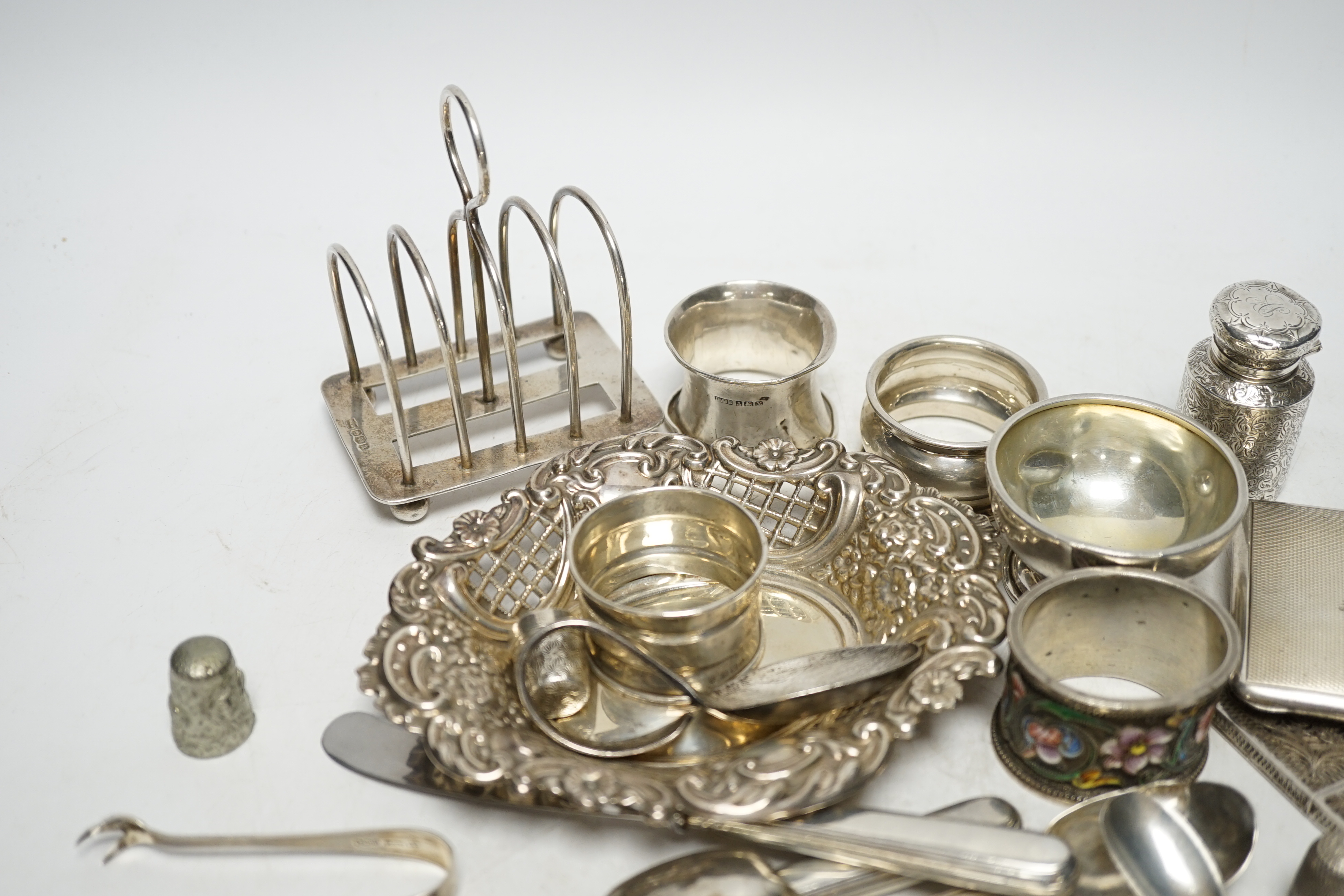 A quantity of assorted silver ad white metal items including a Russian 84 zolotnik and cloisonné enamel napkin ring, bon bon dish, scent bottle, cutlery, toast rack, cigarette case etc. Condition - fair to poor